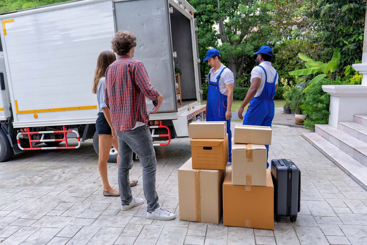 Professional goods move service use truck carry personal belongings door to door transport delivery handover boxes luggage one by one and keep stack on the floor before transfer to place in house